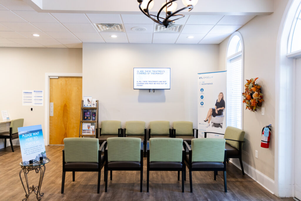 Lobby of primary care office with 2 rows of chairs facing each other. There are signs placed around the space that advertise for treatments offered at this clinic, like IV drip in Jacksonville, NC.